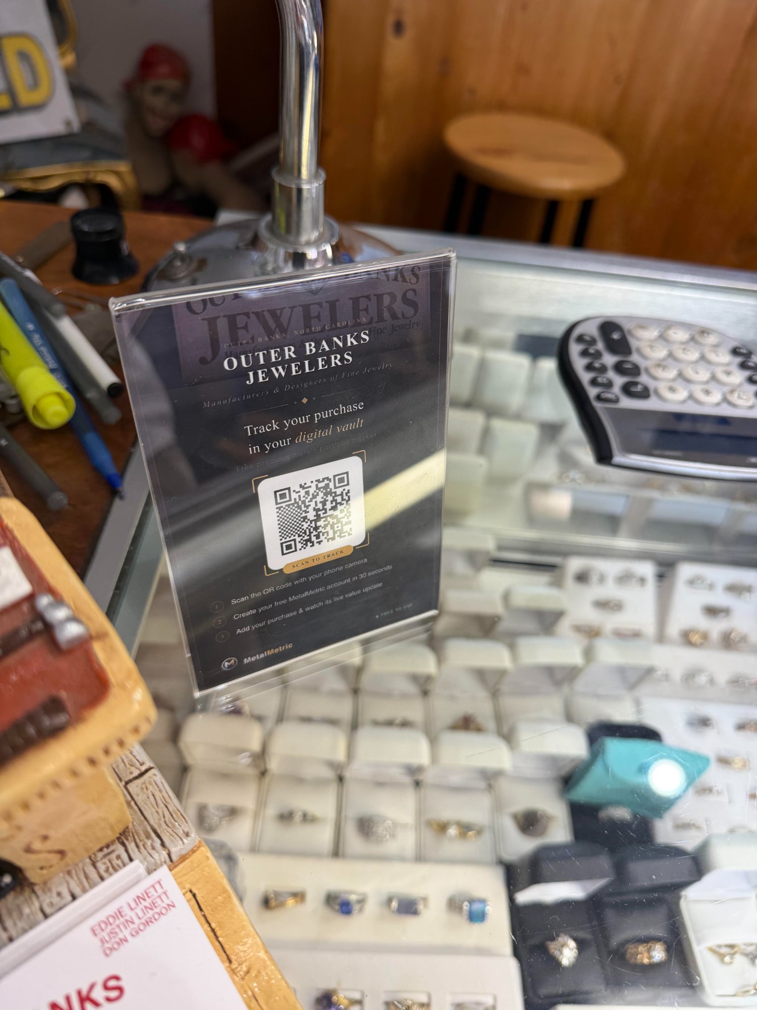 MetalMetric QR placard on display at Outer Banks Jewelers ring counter, Kill Devil Hills NC